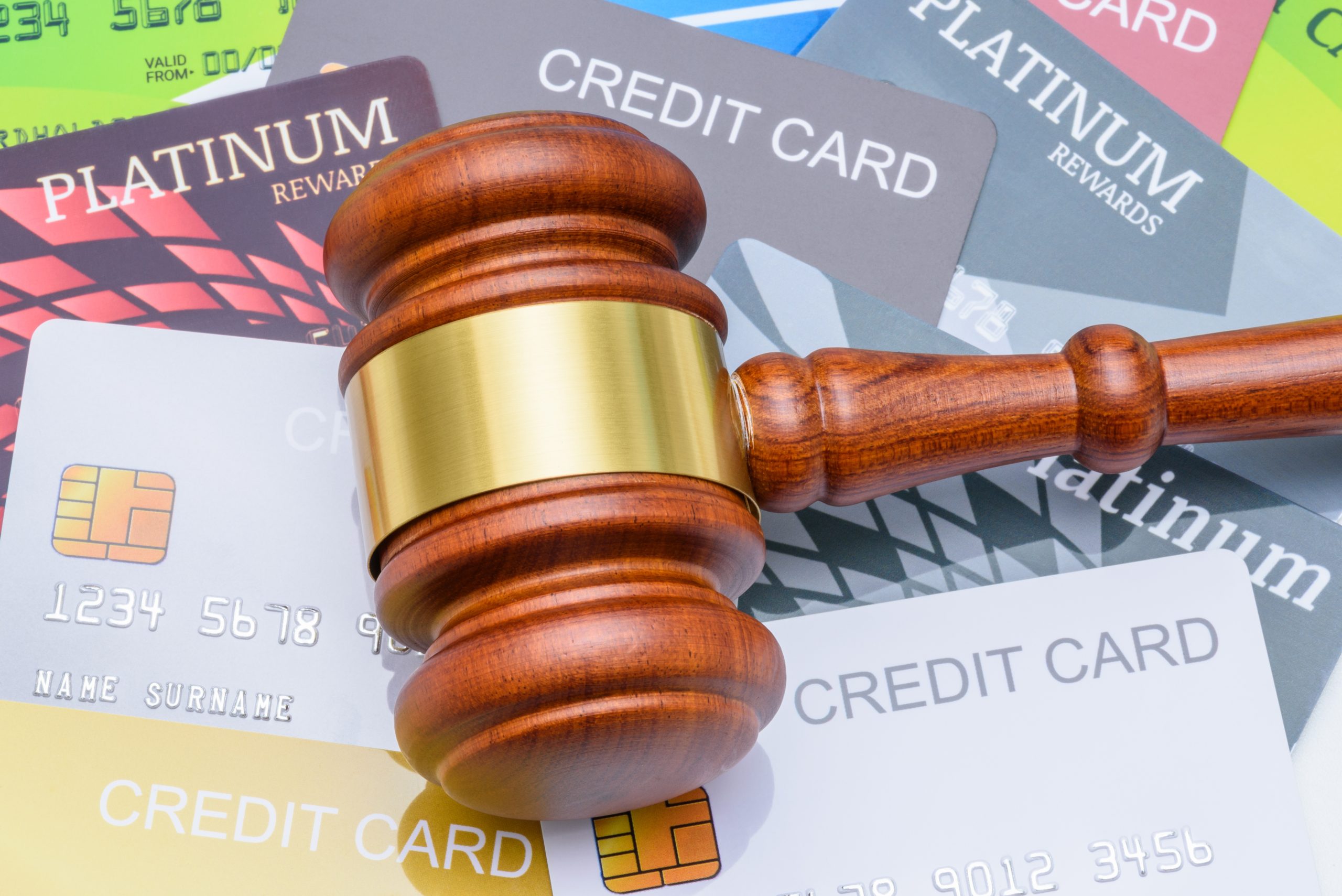 Gavel sitting on top of many credit cards